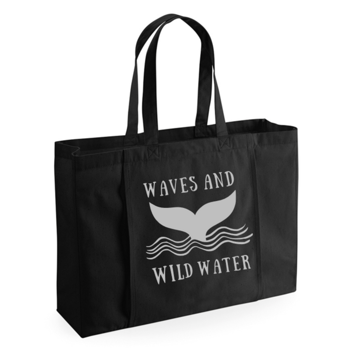 Black Towel Tote bag with the Waves and Wild Water whale tail logo in metallic silver print. This bag is great for wild swimmers and sea dippers because of its large capacity and front towel storage.