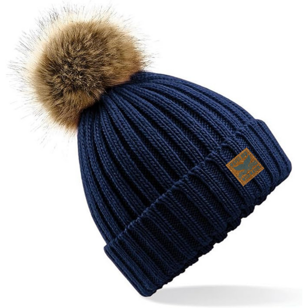 Treat yourself with this stunning deep navy knitted beanie hat. The faux fur pom pom adds a touch of style to your next cold water swim after party, making you the envy of your wild swimming friends!